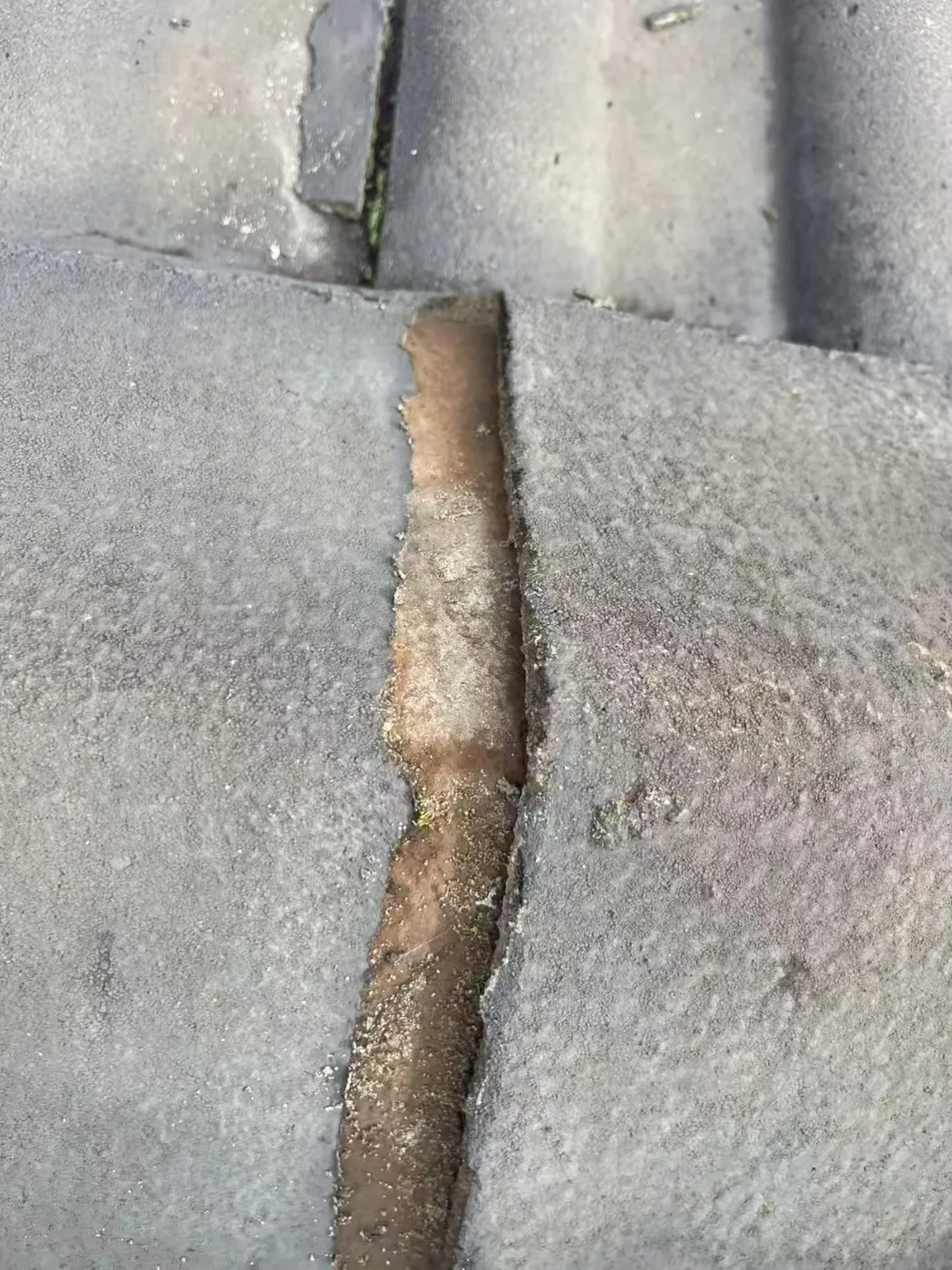 Cracked concrete roof tile close-up