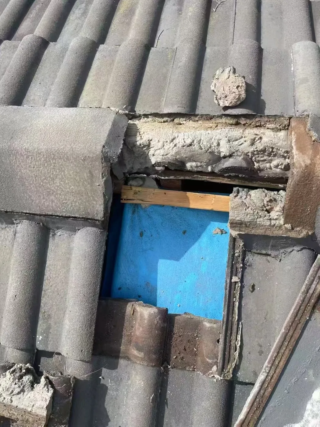 Flashing around an opening in a tiled roof