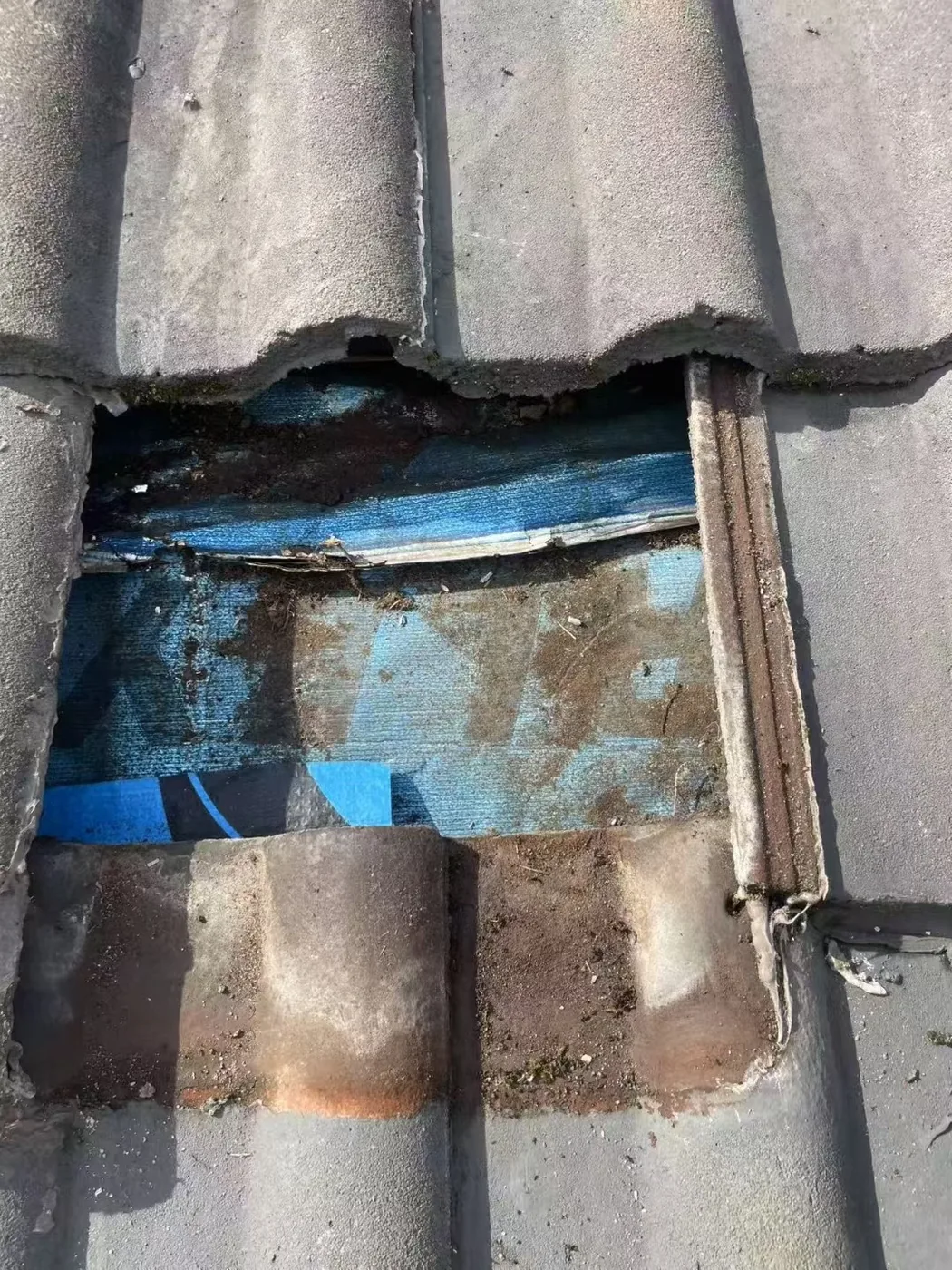 Metal flashing visible beneath roof tiles